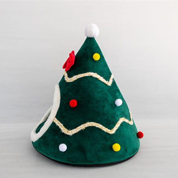 Green pet bed shaped like a Christmas tree with red and yellow decorations on a gray background