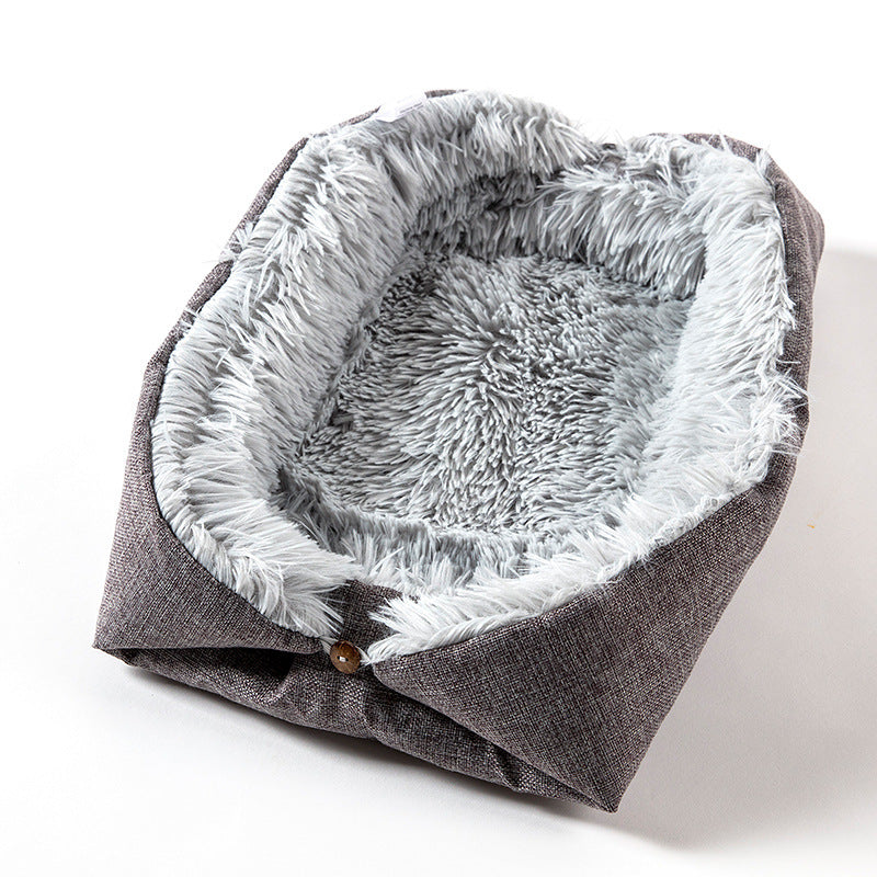 Foldable fluffy pet bed with dark gray exterior and  light gray interior on a white background